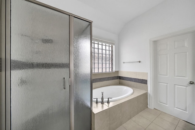 bathroom with lofted ceiling, separate shower and tub, and tile patterned flooring