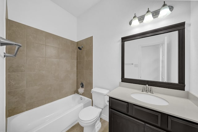 full bathroom with toilet, vanity, and tiled shower / bath