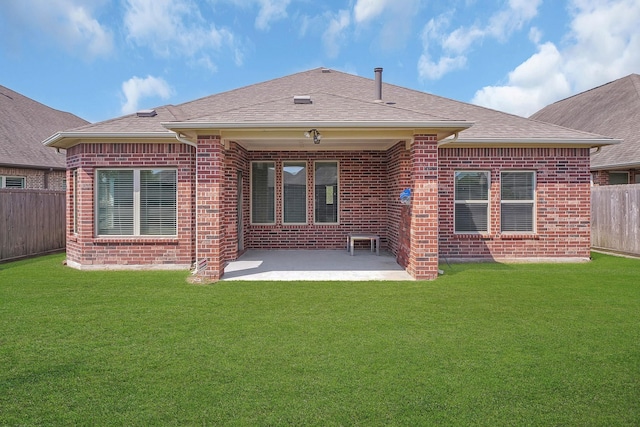 rear view of house with a patio and a lawn