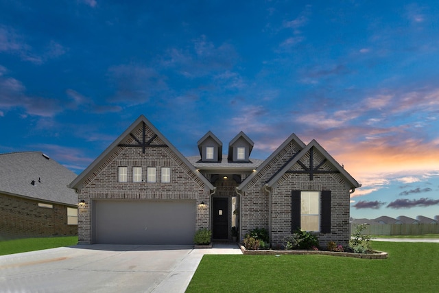 view of front facade with a garage and a yard