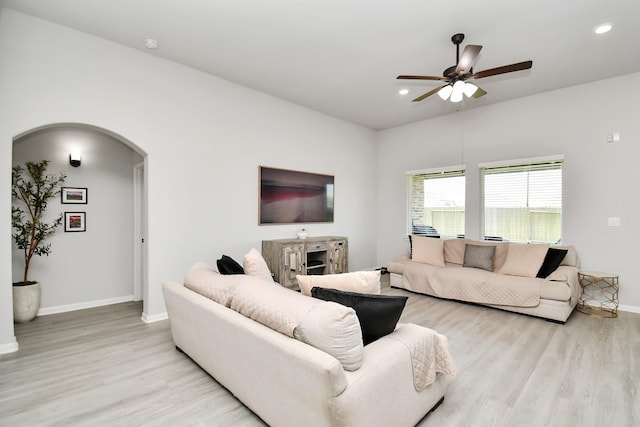 living room with ceiling fan and light hardwood / wood-style flooring