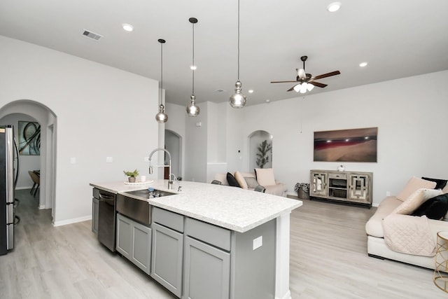 kitchen with dishwasher, gray cabinets, pendant lighting, a center island with sink, and sink