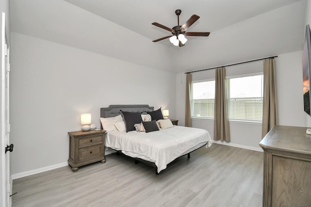 bedroom featuring ceiling fan, light wood-type flooring, and lofted ceiling