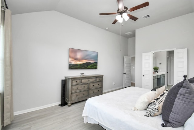 bedroom with ceiling fan, light hardwood / wood-style floors, and vaulted ceiling