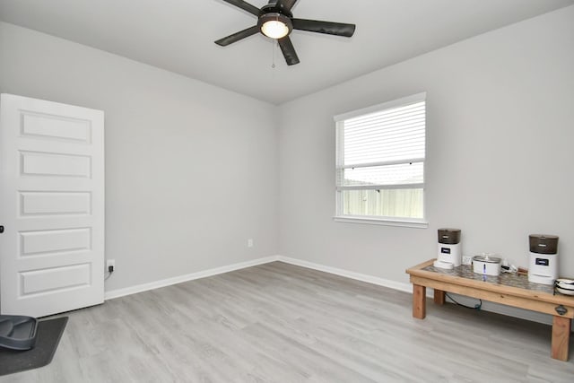 spare room with ceiling fan and light wood-type flooring