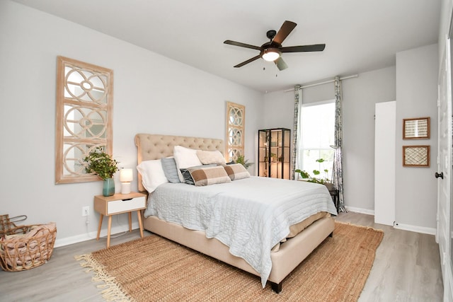 bedroom with ceiling fan and light wood-type flooring