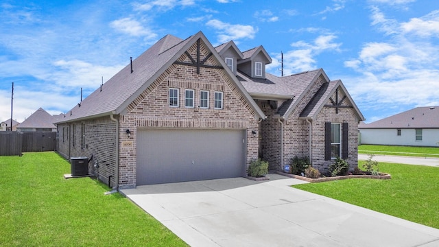 view of front of house with a garage, a front lawn, and central AC unit