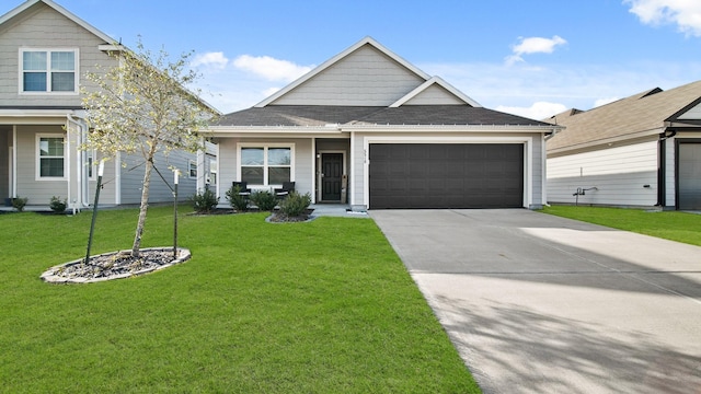 view of front of home with a front yard and a garage