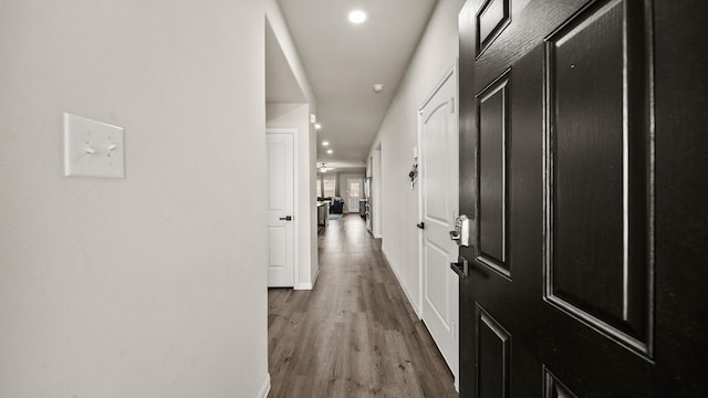 corridor with hardwood / wood-style floors