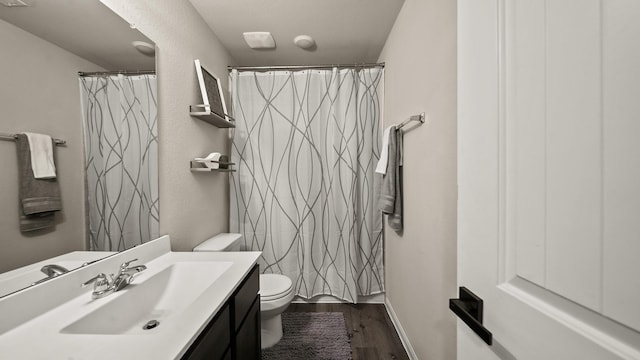 bathroom featuring vanity, toilet, curtained shower, and wood-type flooring