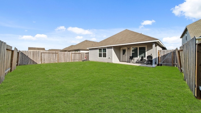 back of house featuring a patio area and a yard