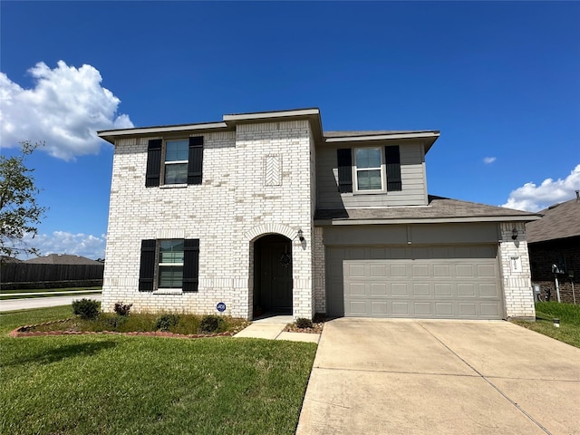 view of front of property featuring a garage and a front yard