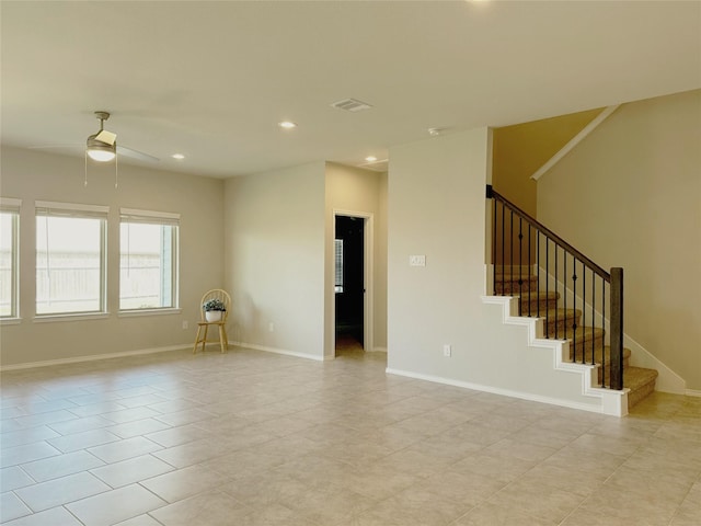 unfurnished room with ceiling fan and light tile patterned floors