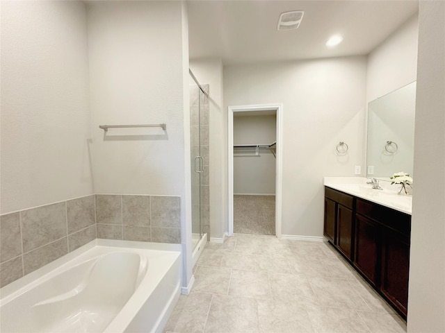 bathroom featuring tile patterned floors, separate shower and tub, and vanity