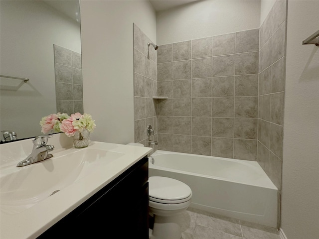 full bathroom with tile patterned floors, tiled shower / bath combo, vanity, and toilet