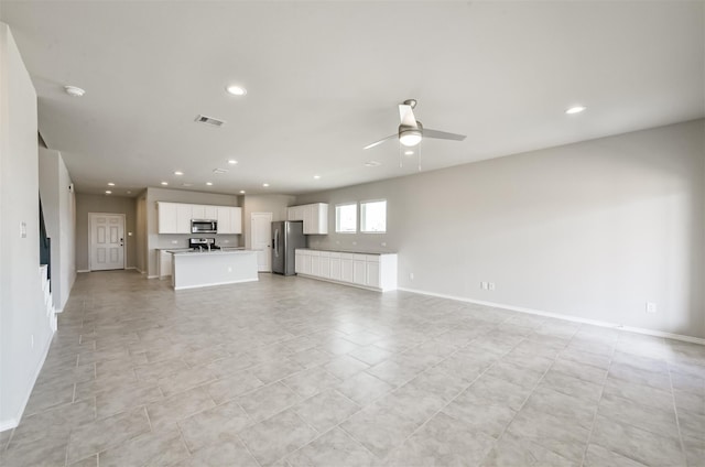 unfurnished living room with ceiling fan and light tile patterned flooring