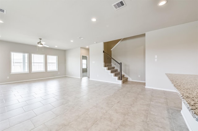 unfurnished living room with ceiling fan and light tile patterned floors