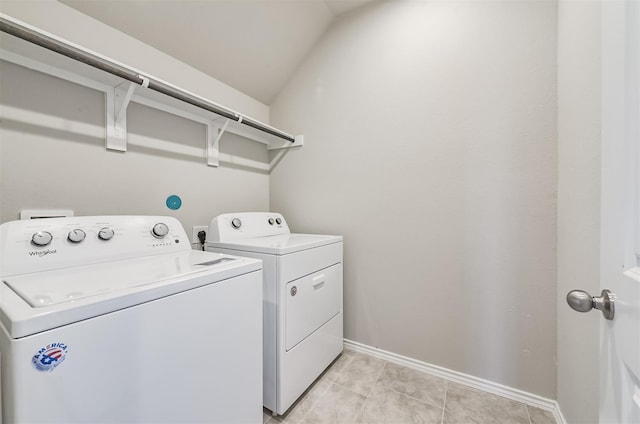 laundry room featuring light tile patterned floors and washing machine and clothes dryer