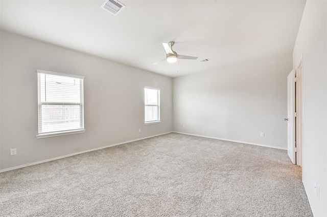 empty room with ceiling fan and light colored carpet