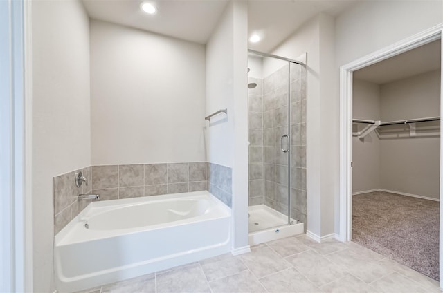 bathroom with plus walk in shower and tile patterned flooring