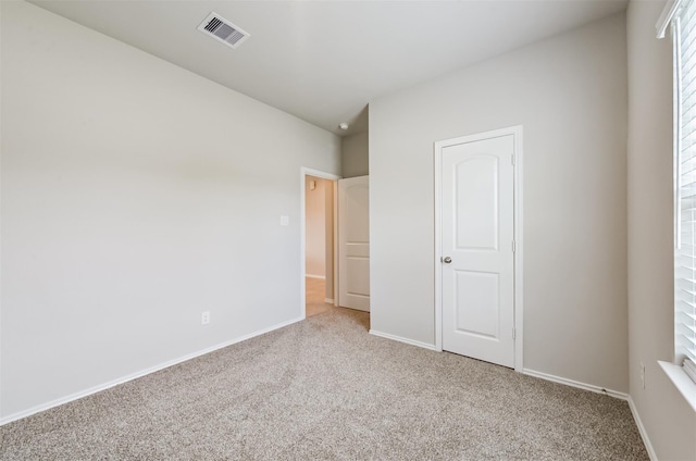 unfurnished bedroom featuring light carpet