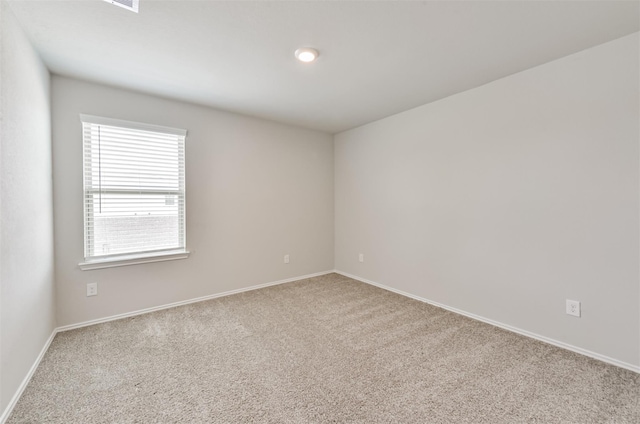 carpeted spare room featuring a wealth of natural light