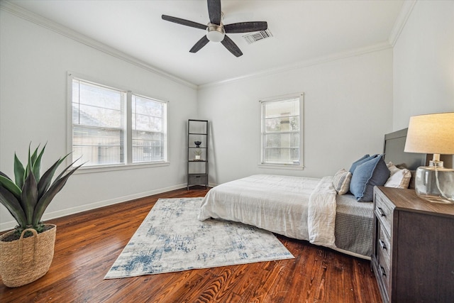 bedroom featuring ceiling fan, ornamental molding, and dark hardwood / wood-style flooring