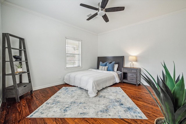 bedroom featuring ornamental molding, dark wood-type flooring, and ceiling fan