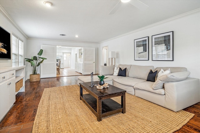 living room featuring hardwood / wood-style flooring, crown molding, and ceiling fan