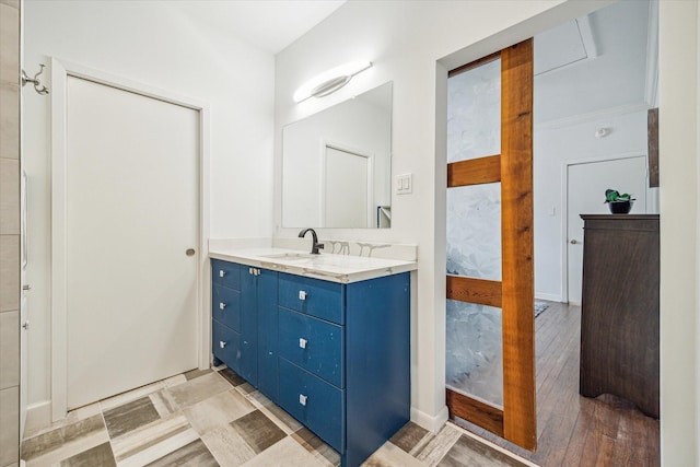 bathroom with vanity, hardwood / wood-style floors, and crown molding