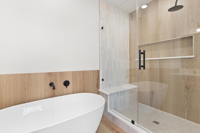 bathroom with plus walk in shower and hardwood / wood-style floors