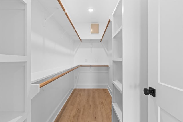 spacious closet featuring light hardwood / wood-style floors