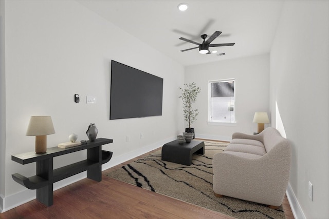 living room featuring ceiling fan and hardwood / wood-style floors