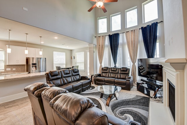 living room featuring ceiling fan and light hardwood / wood-style floors