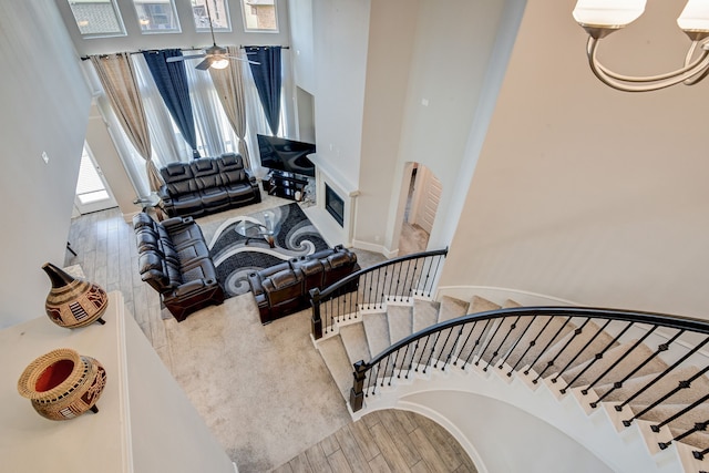 stairway with ceiling fan and hardwood / wood-style floors