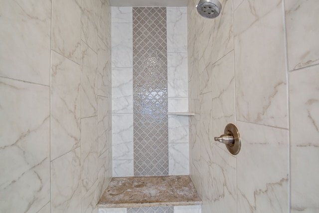 bathroom with a tile shower