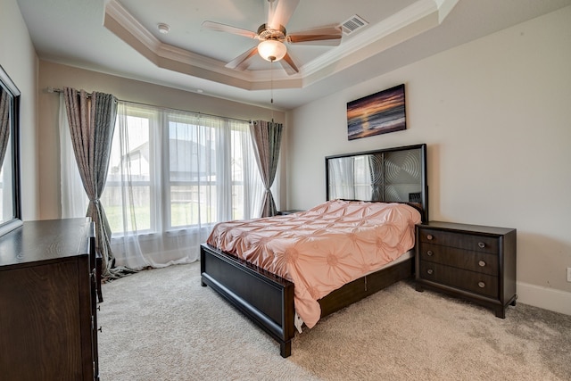 bedroom featuring light carpet, ceiling fan, ornamental molding, and a raised ceiling