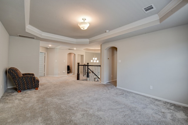 living area featuring carpet, a tray ceiling, and crown molding