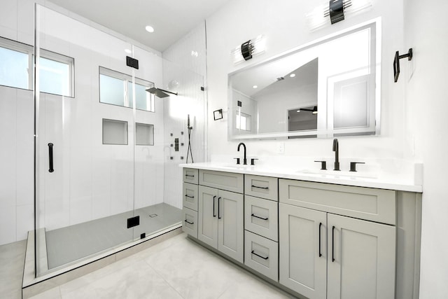 bathroom featuring a shower with shower door and vanity