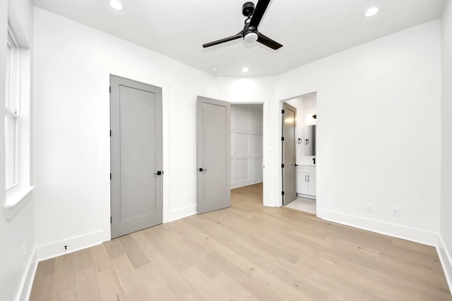 unfurnished bedroom with ceiling fan, connected bathroom, and light hardwood / wood-style flooring