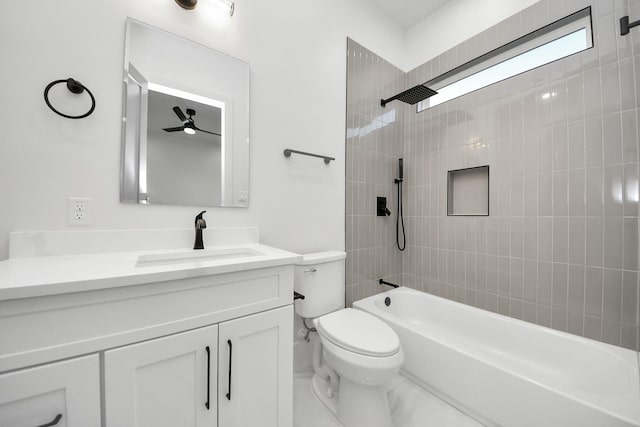 full bathroom featuring ceiling fan, tiled shower / bath combo, vanity, and toilet