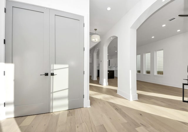 corridor with light wood-type flooring