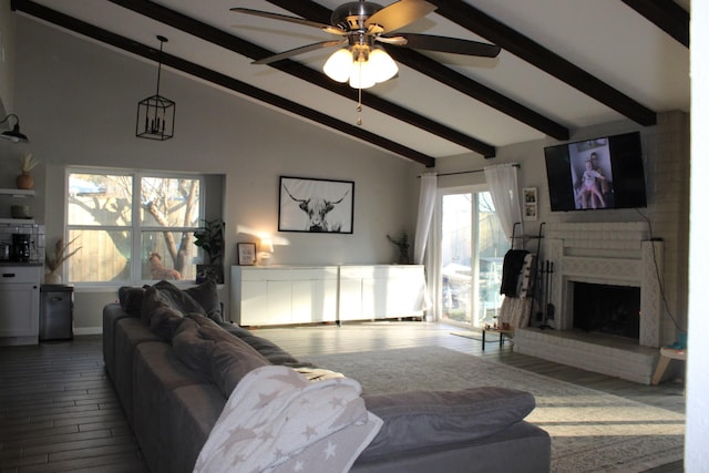 living room featuring beamed ceiling, hardwood / wood-style floors, a fireplace, high vaulted ceiling, and ceiling fan