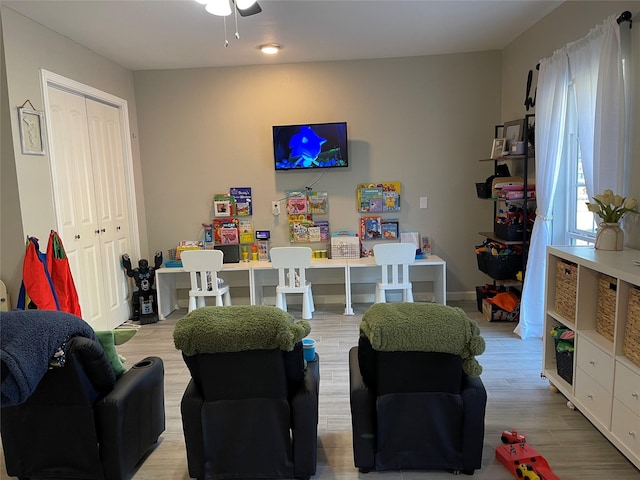 rec room with light hardwood / wood-style flooring