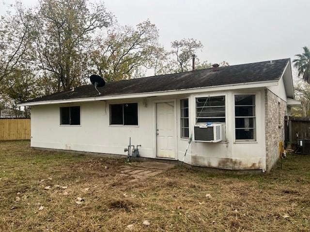 back of house with cooling unit and a yard