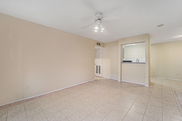 spare room featuring ceiling fan and light tile patterned flooring