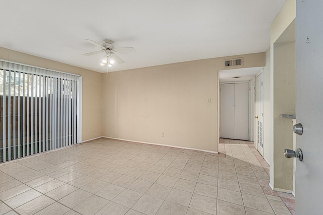 tiled empty room with ceiling fan