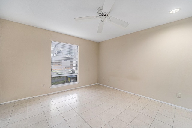 unfurnished room featuring ceiling fan and light tile patterned floors