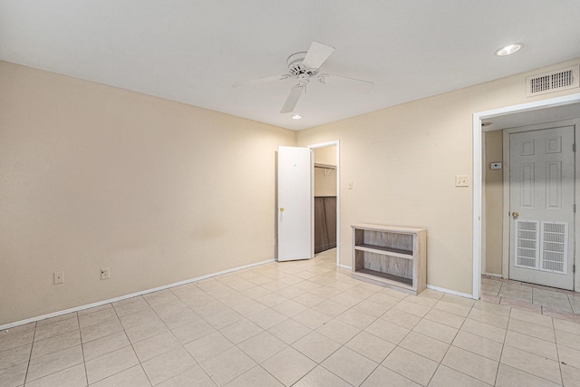 unfurnished living room featuring ceiling fan and light tile patterned floors