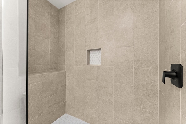 bathroom with tiled shower